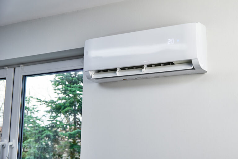 Airco-unit aan de wand bij een raam